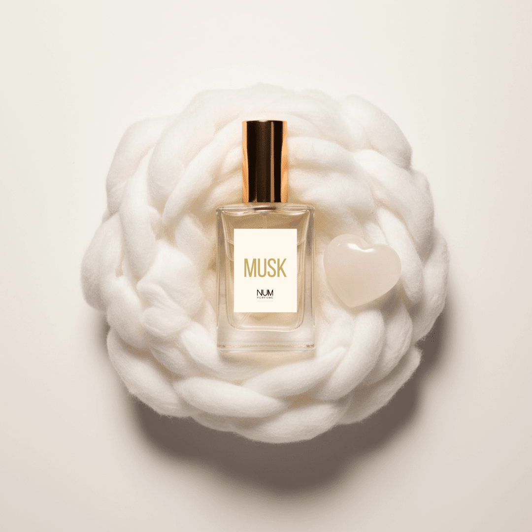 MUSK NUM Perfume - frasco con corazón de selenita sobre nido de algodón